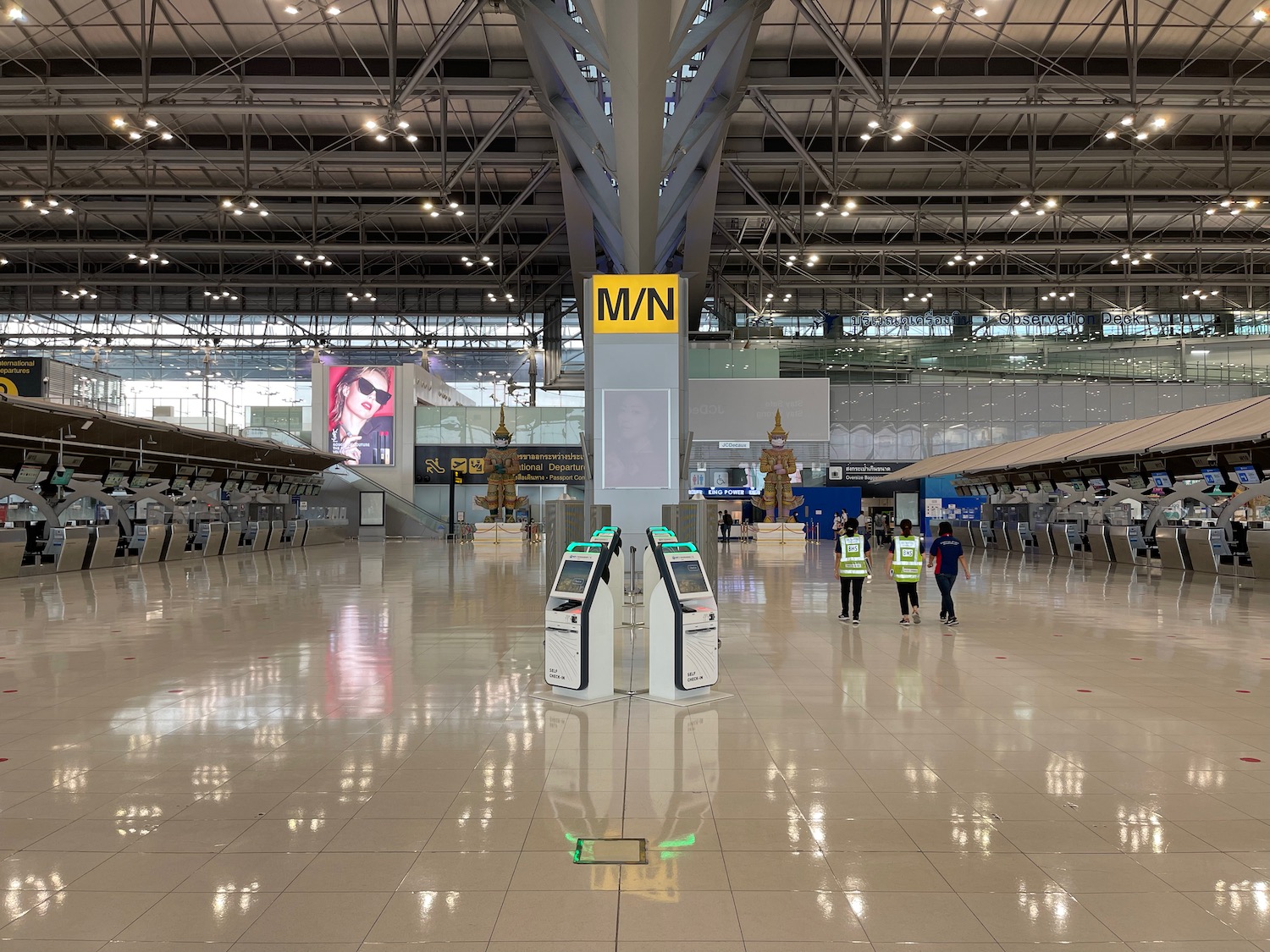 a group of people in a large airport terminal