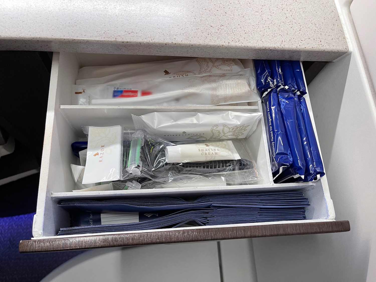 a drawer with a drawer full of toothbrushes and toothpaste