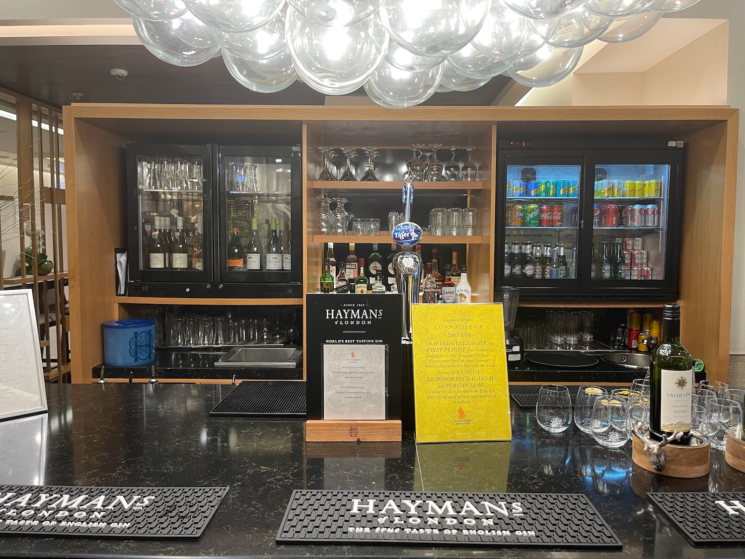 a bar with a drink dispenser and glasses