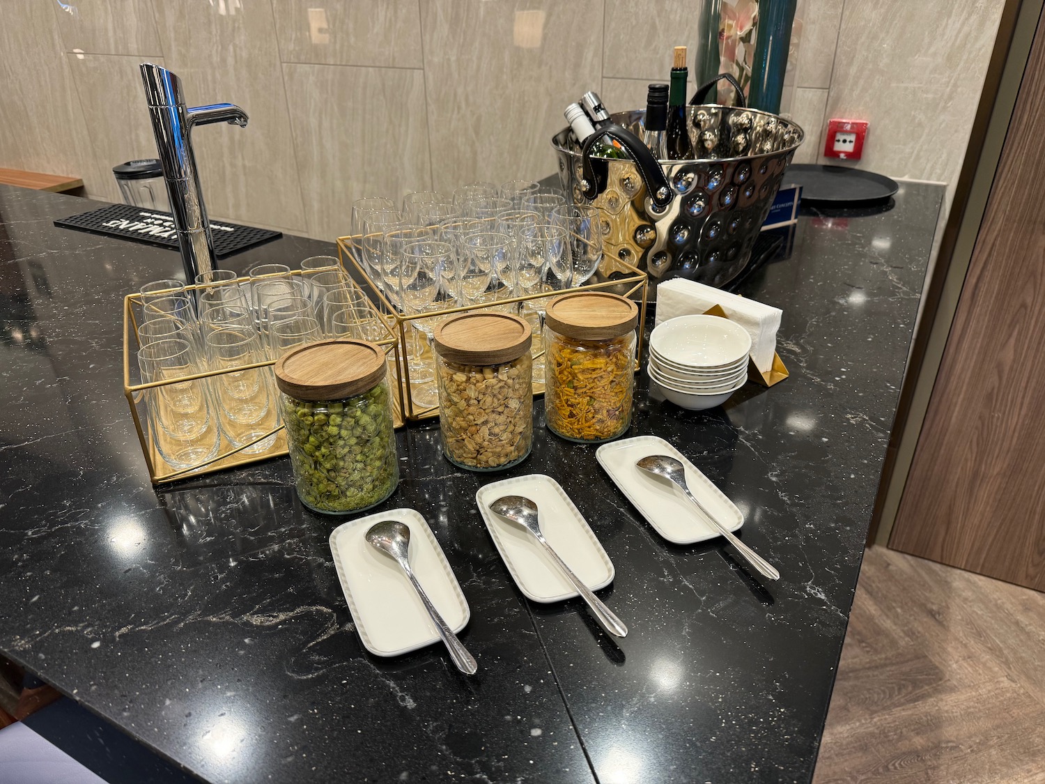 a counter with a variety of dishes and spoons