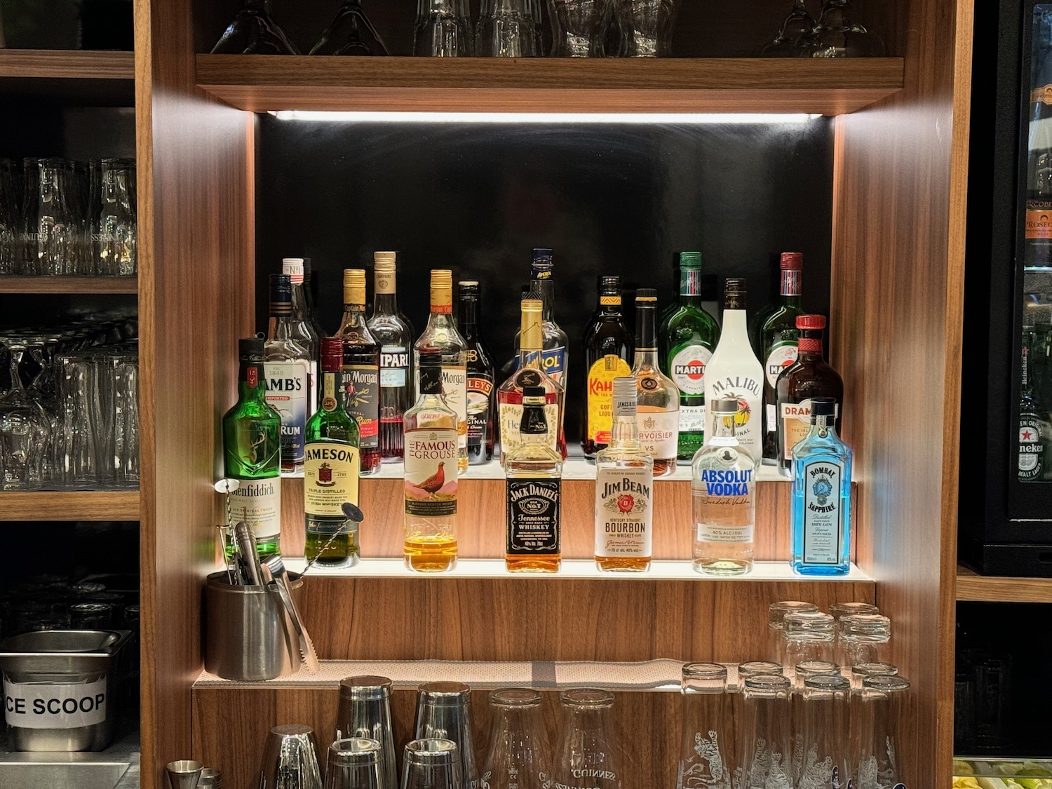 a shelf with bottles and glasses