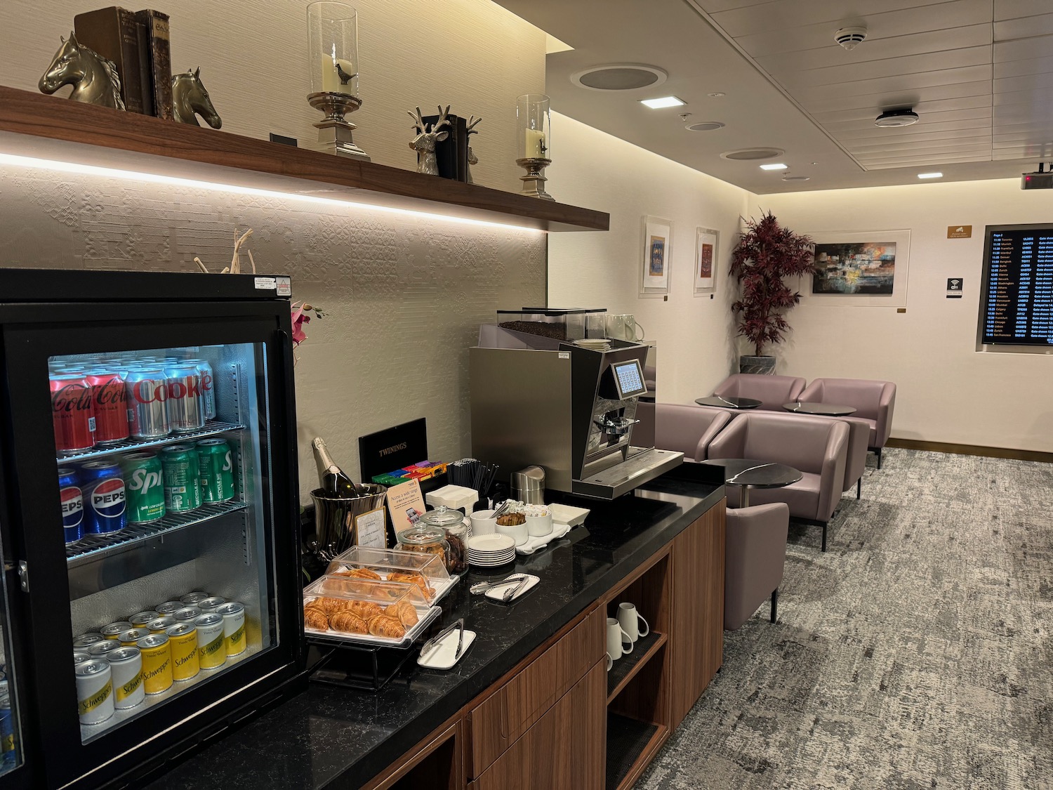 a coffee machine and drinks on a counter in a room