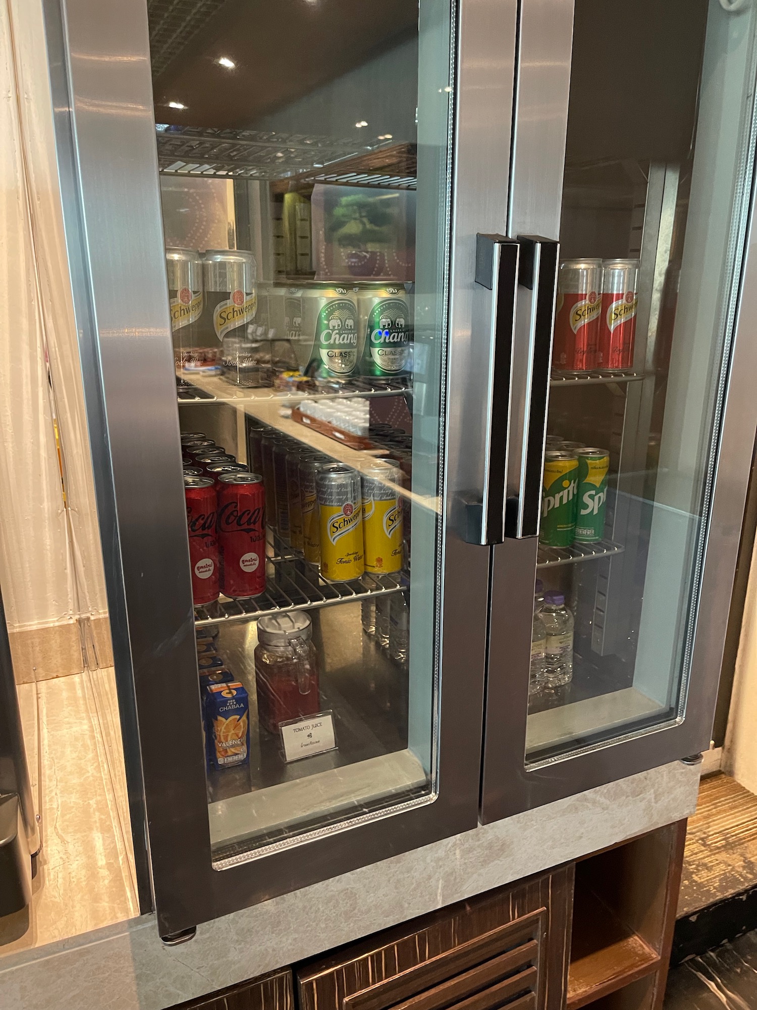 a refrigerator with cans and cans of soda