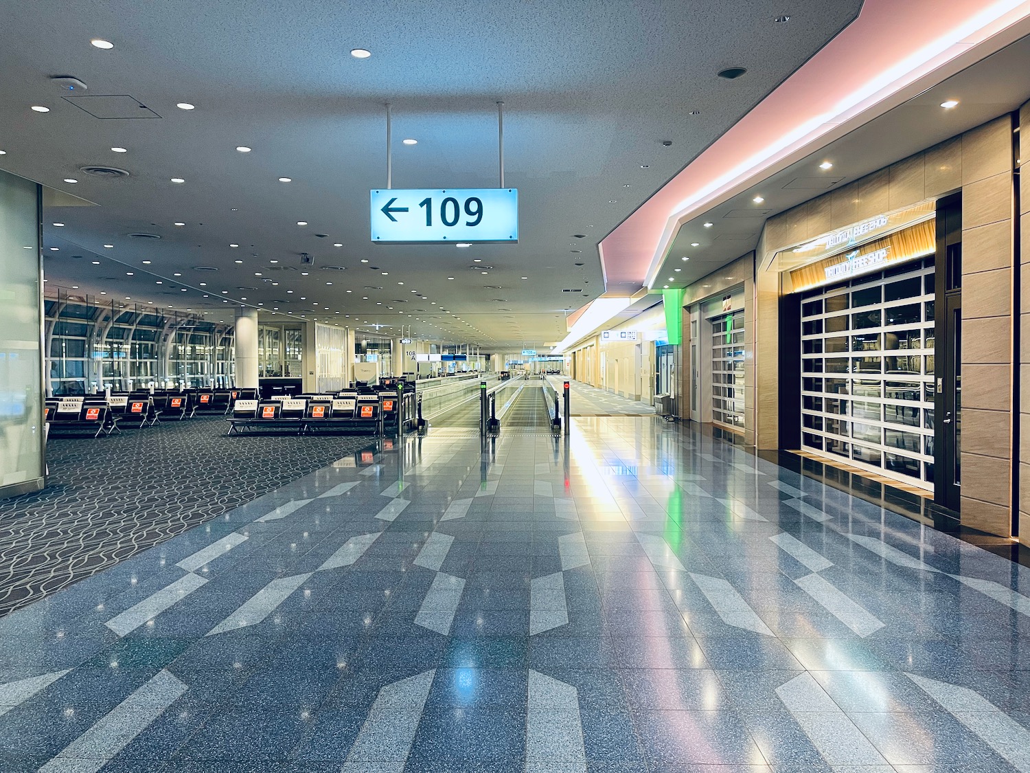 an empty airport with a sign