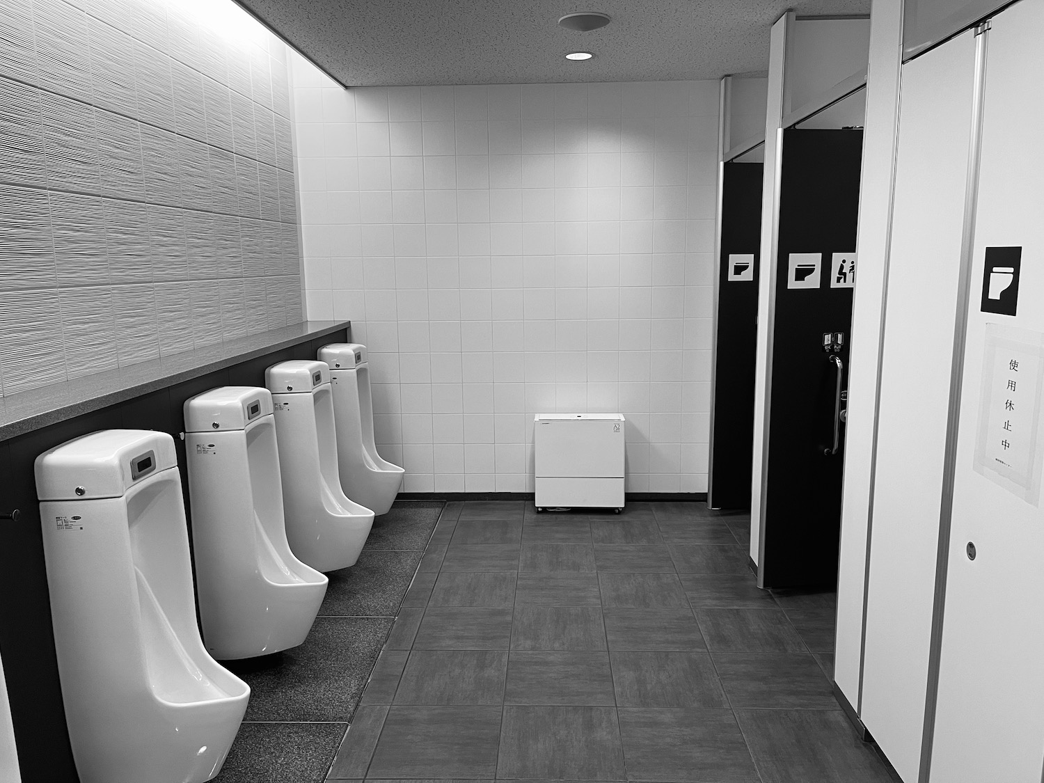 a row of urinals in a bathroom