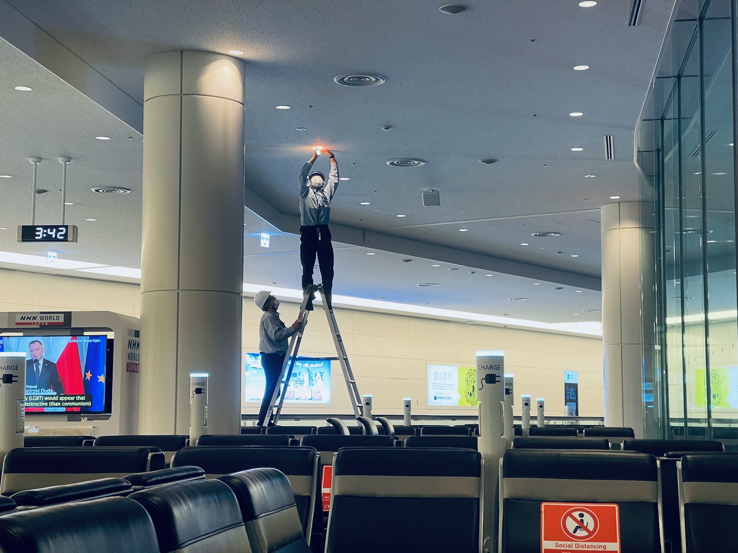a man on a ladder in an airport