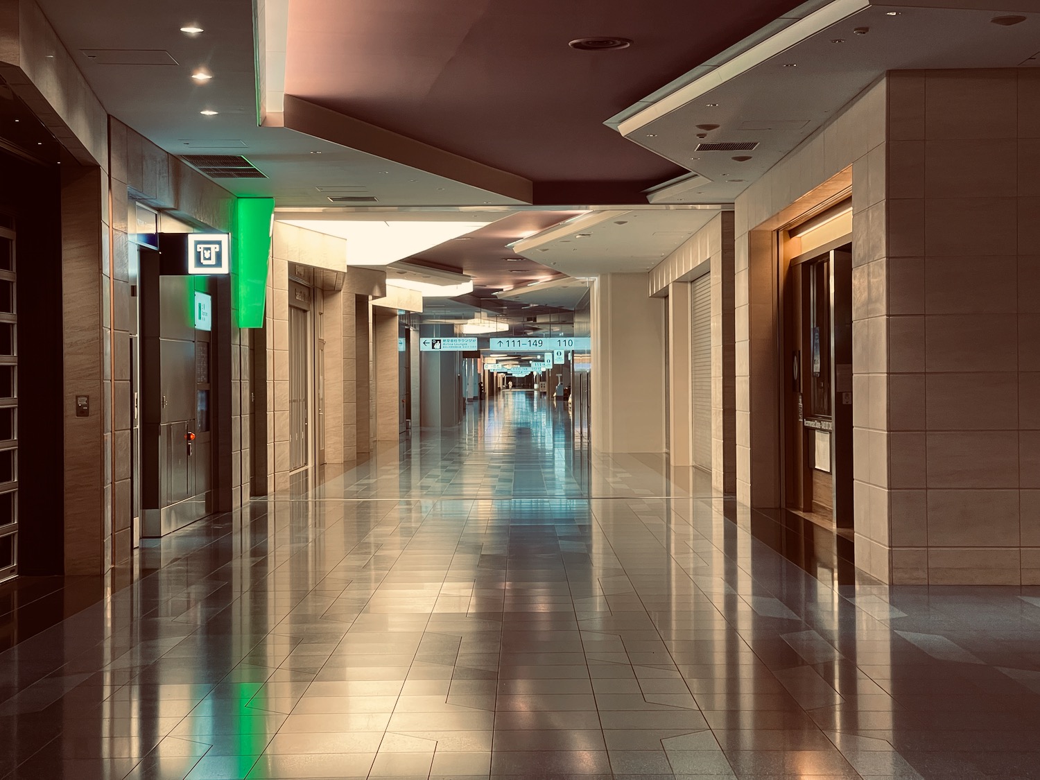 a hallway with doors and signs