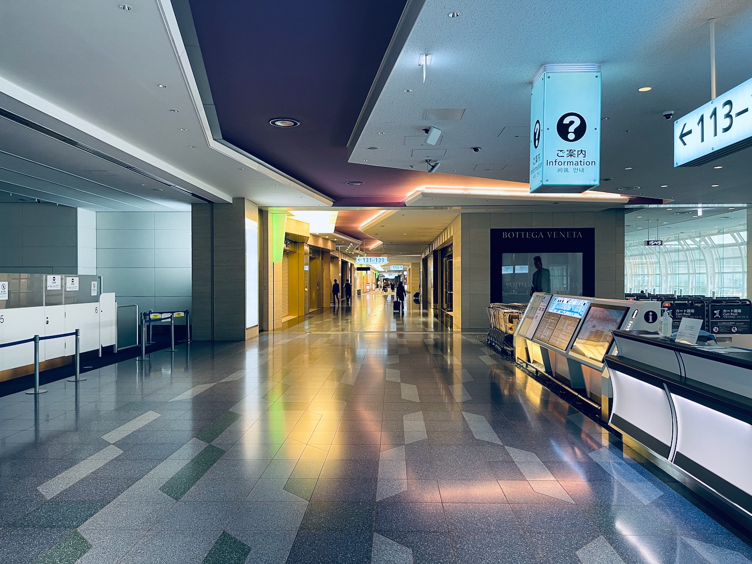 a hallway with people walking in the background