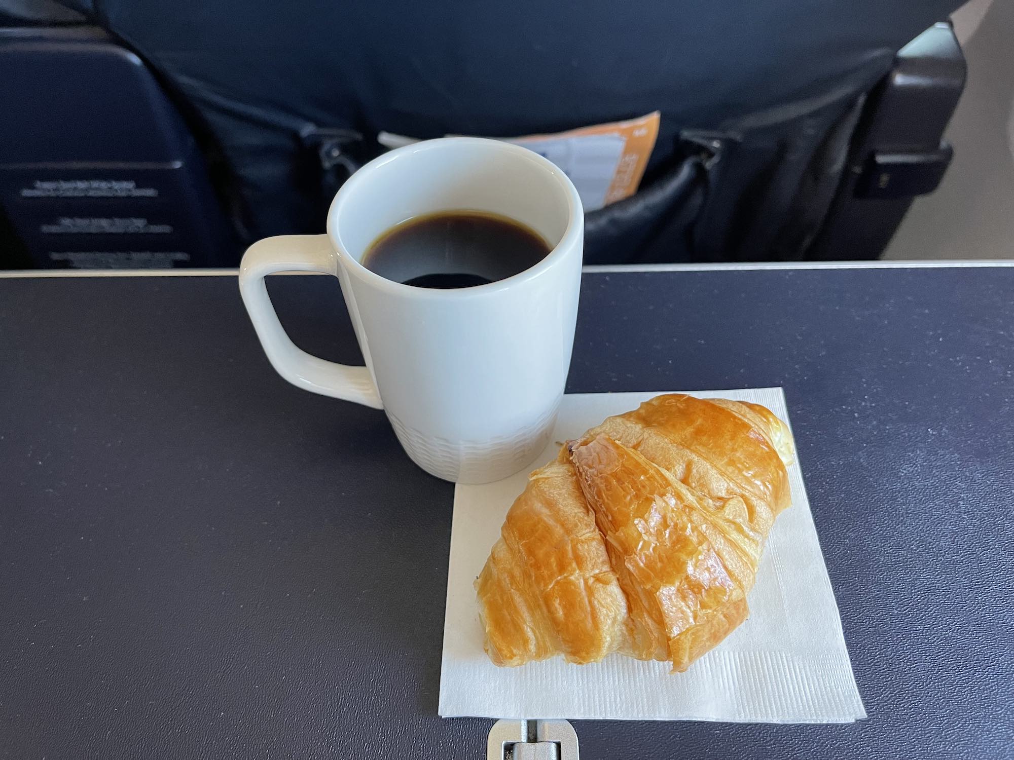 a croissant and a cup of coffee