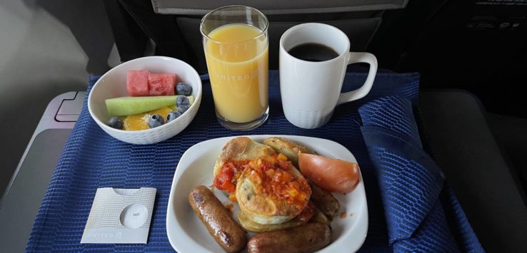 a plate of food and drinks on a tray