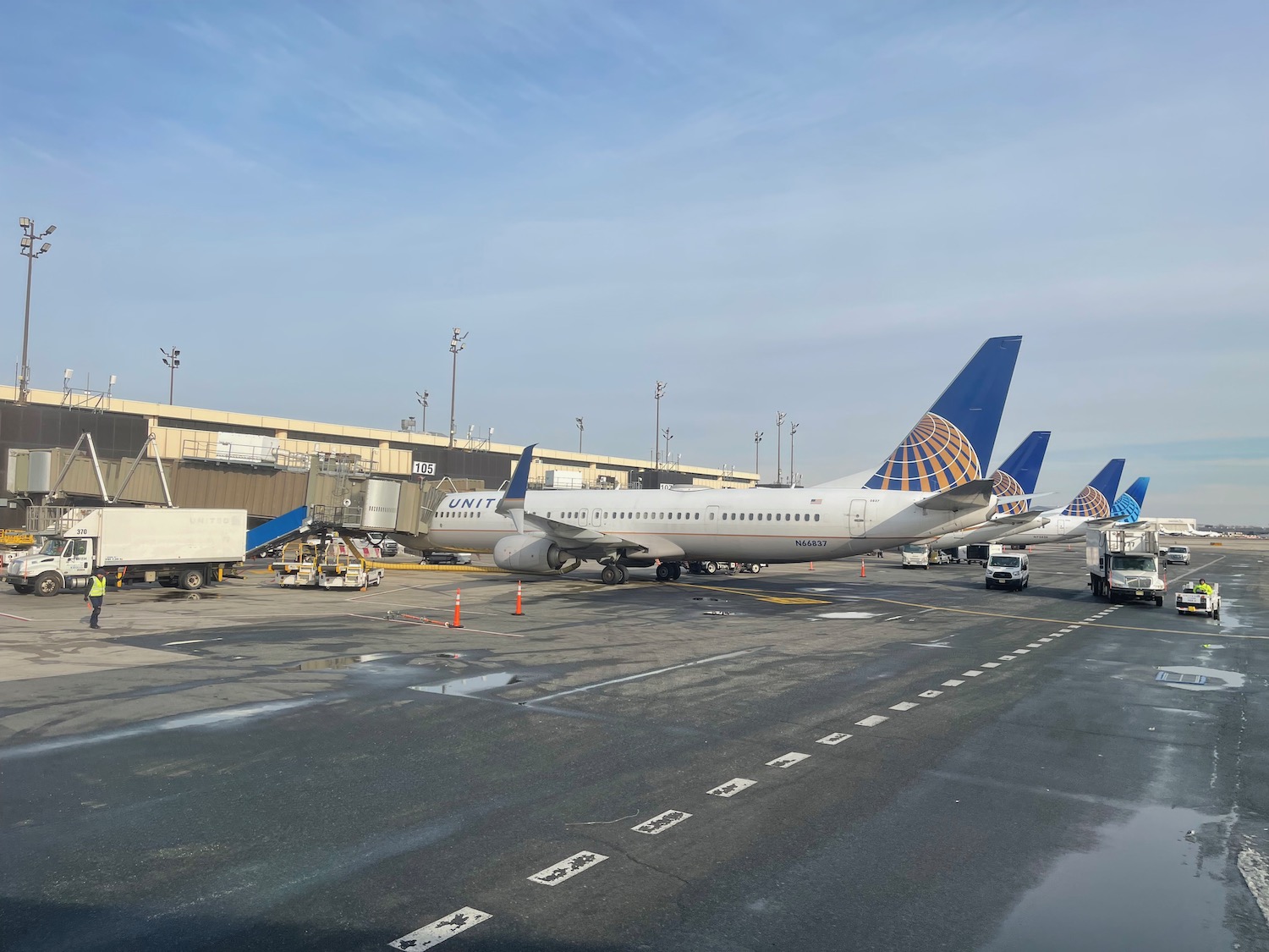 a group of airplanes parked at an airport