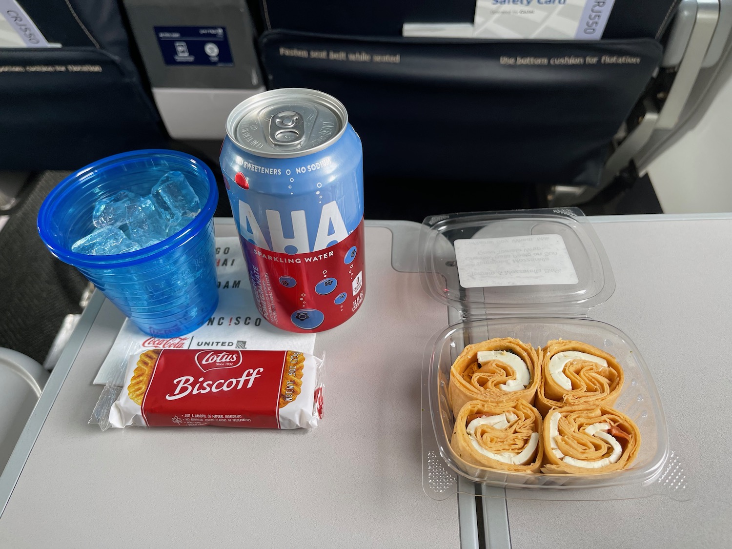 a can of soda and food on a table