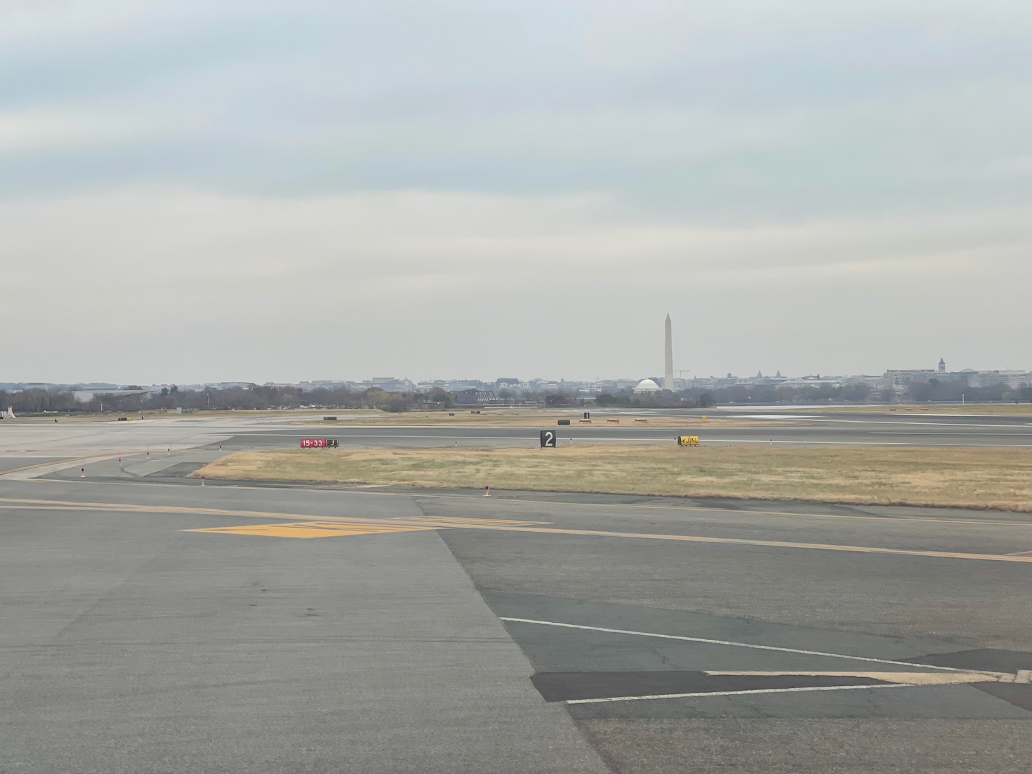 a runway with a monument in the background