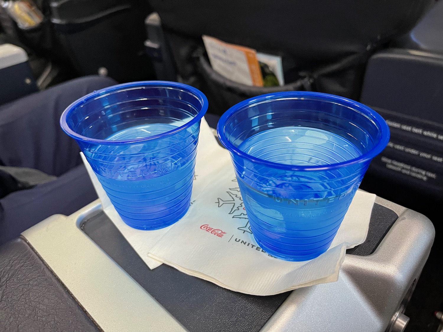 two blue plastic cups on a napkin