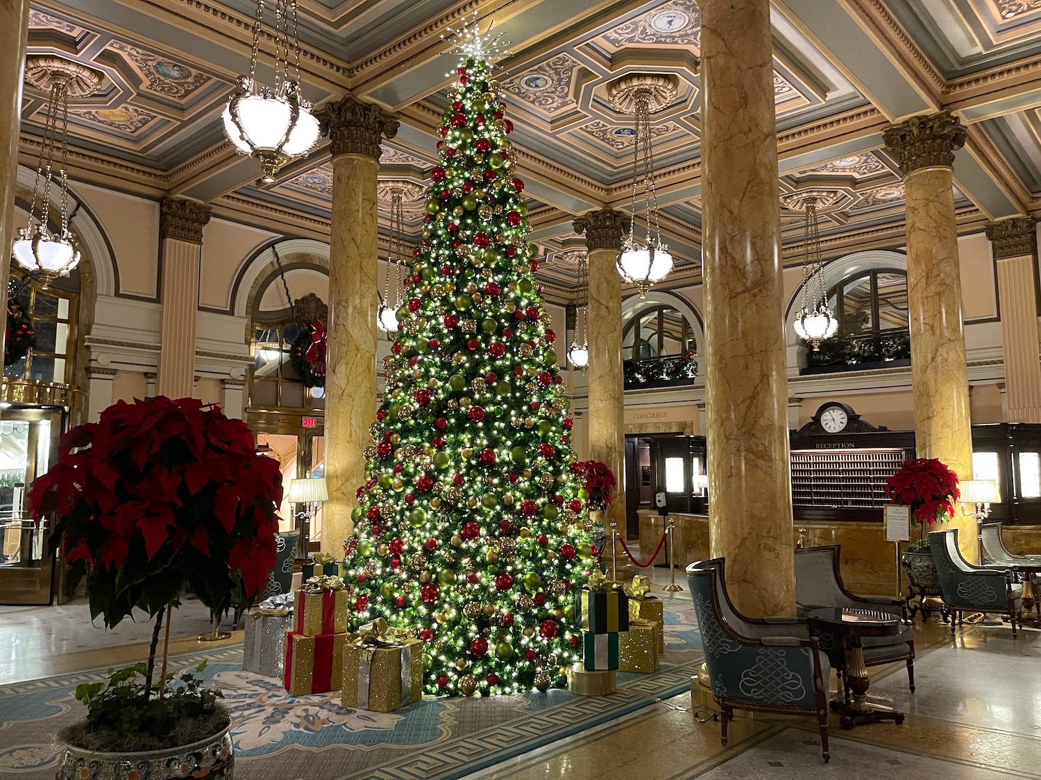 a christmas tree in a room with columns and lights