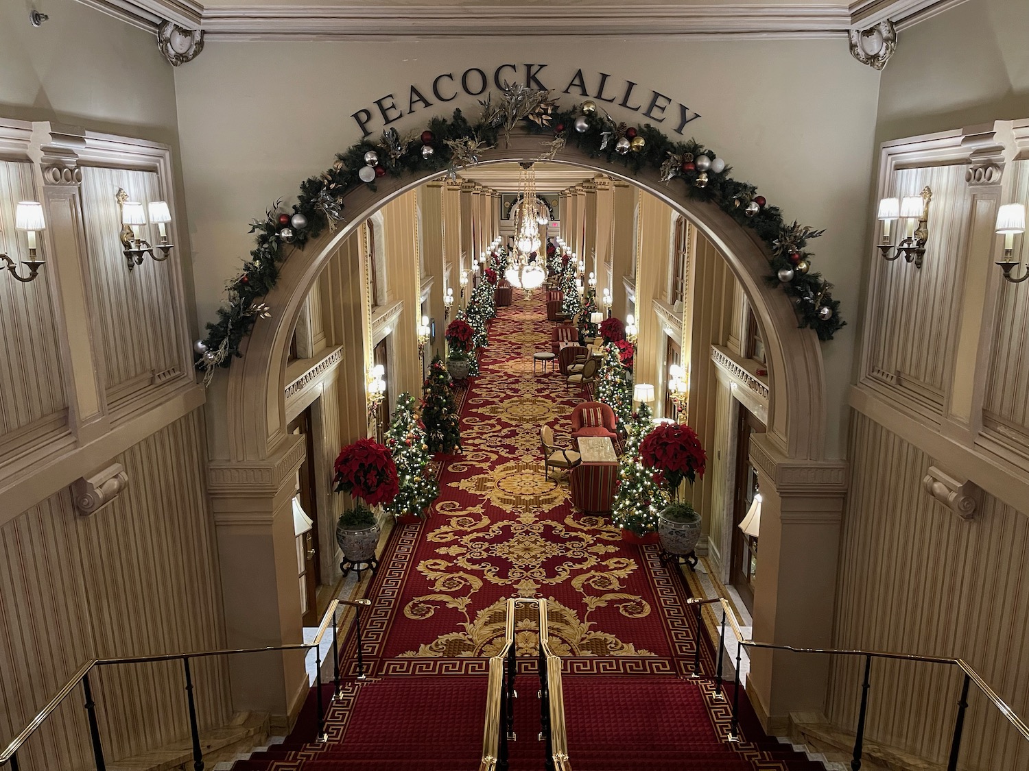 a hallway with red carpet and decorations