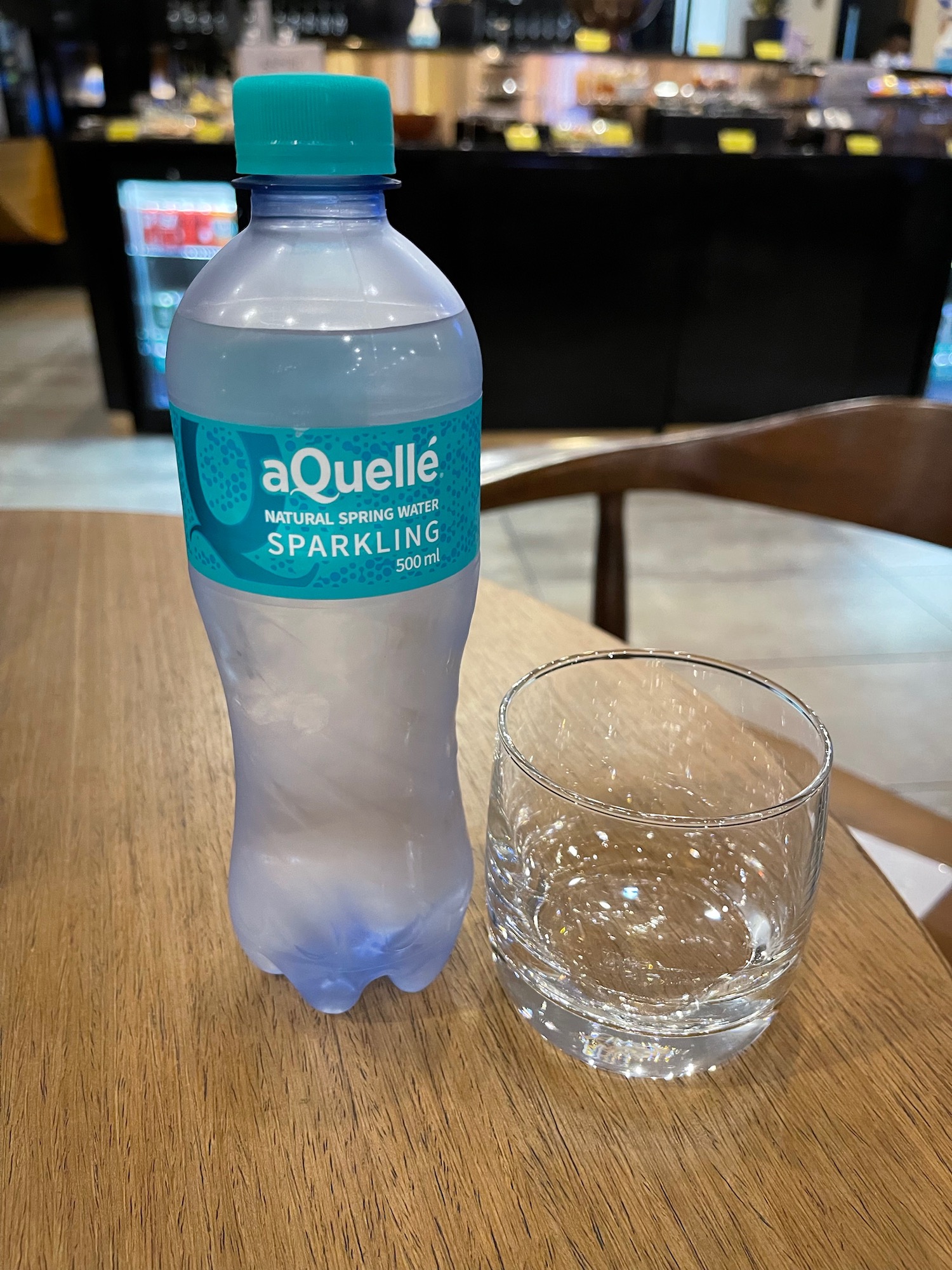 a bottle of water and a glass on a table