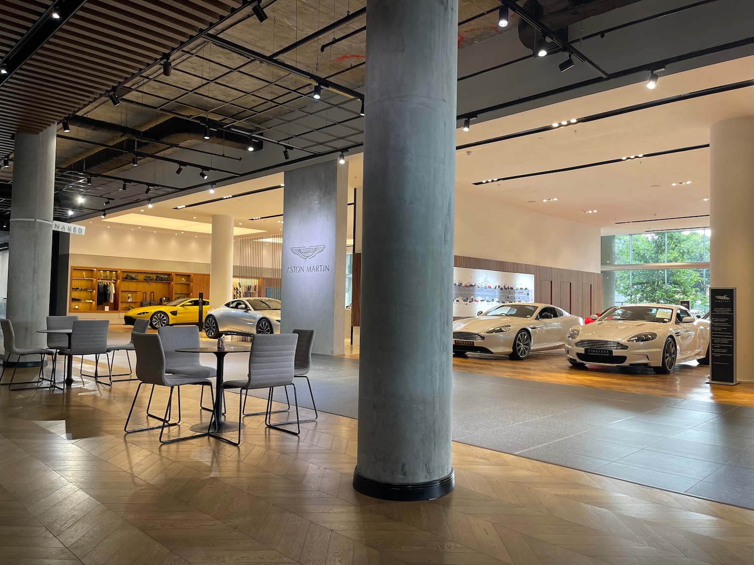 a room with a large pillar and cars