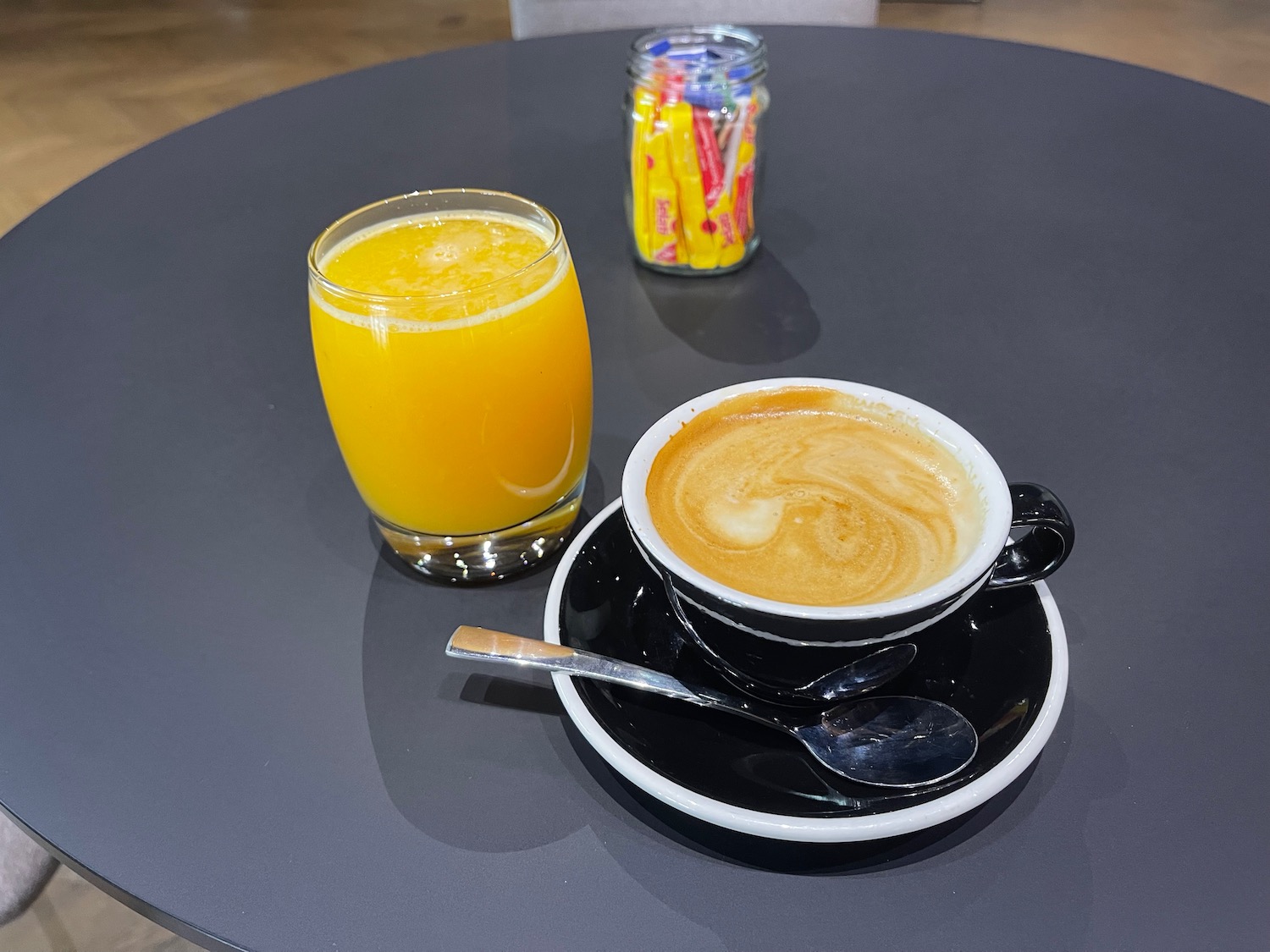 a cup of coffee and a glass of orange juice on a table