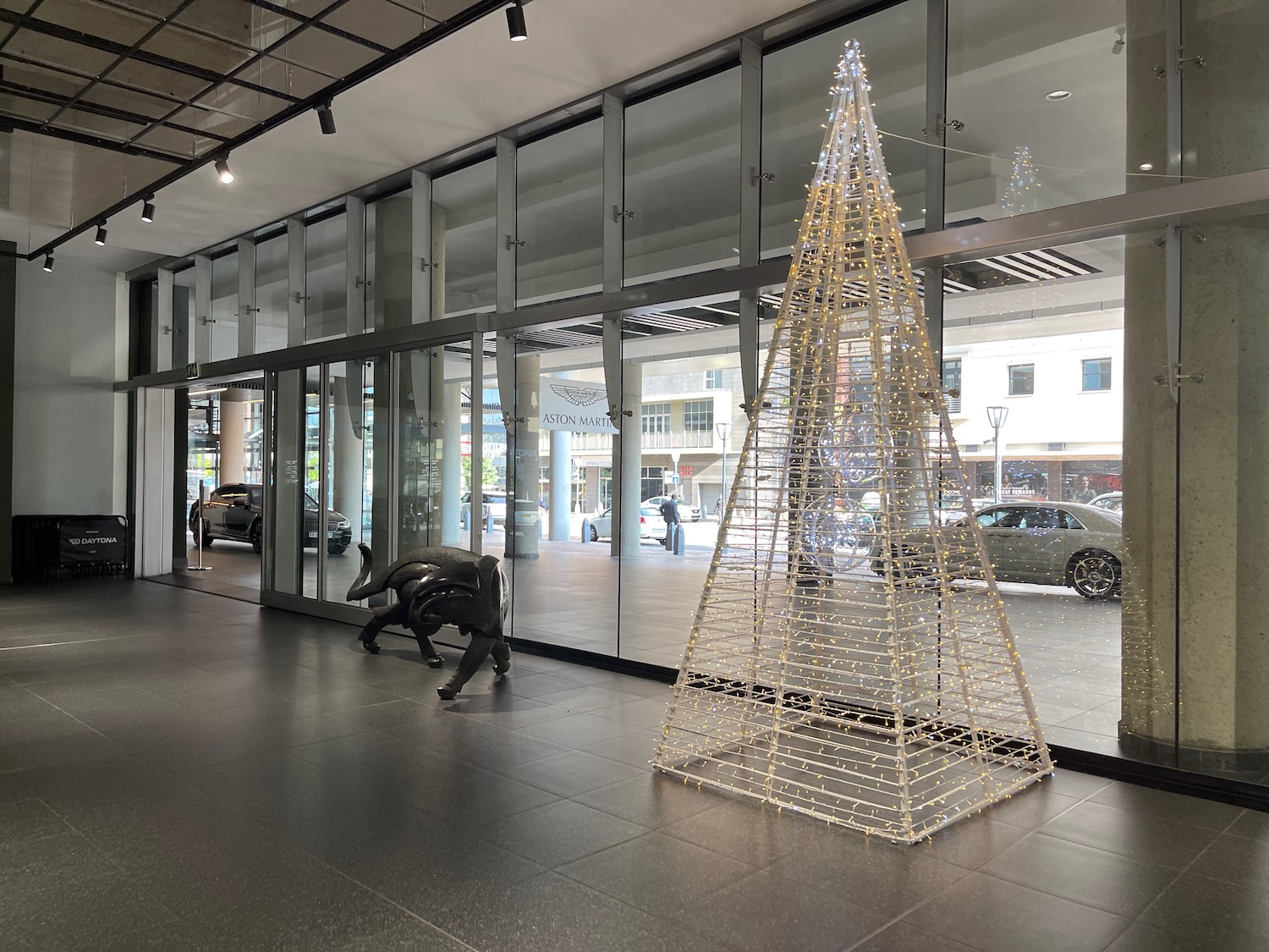 a wire christmas tree in front of a building