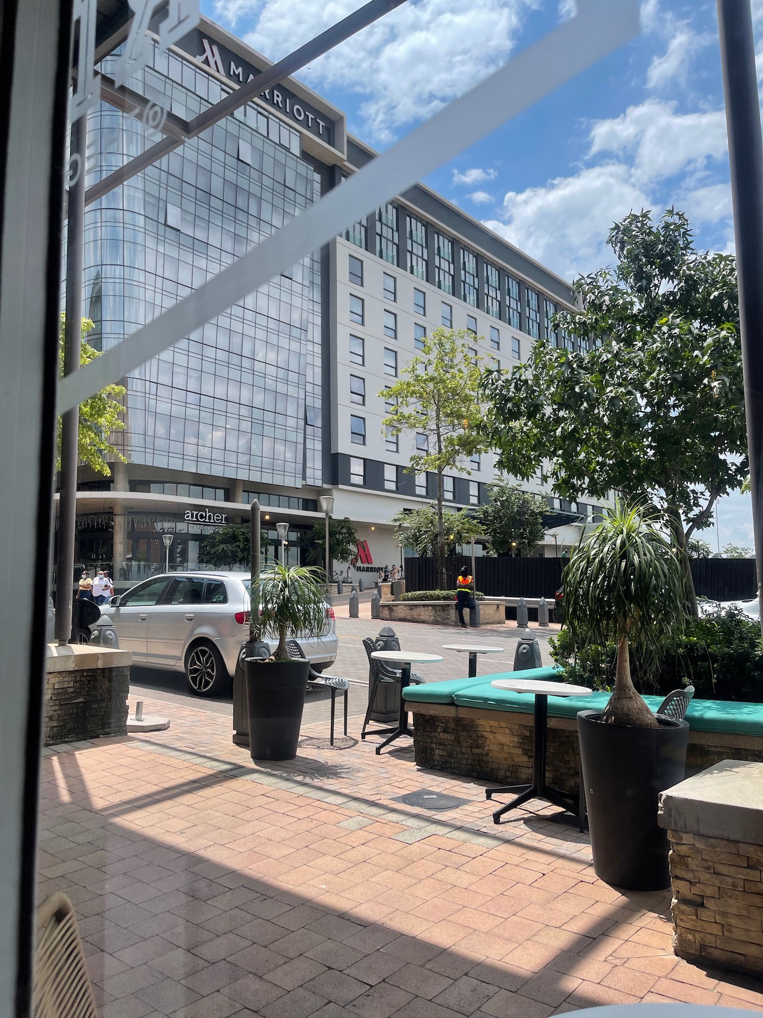 a building with trees and cars