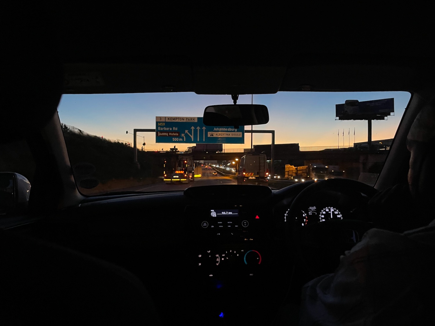 view of a road at night from inside a car