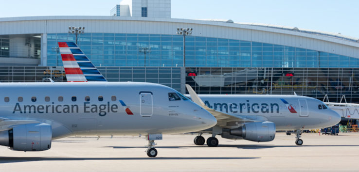 two airplanes parked in front of a building