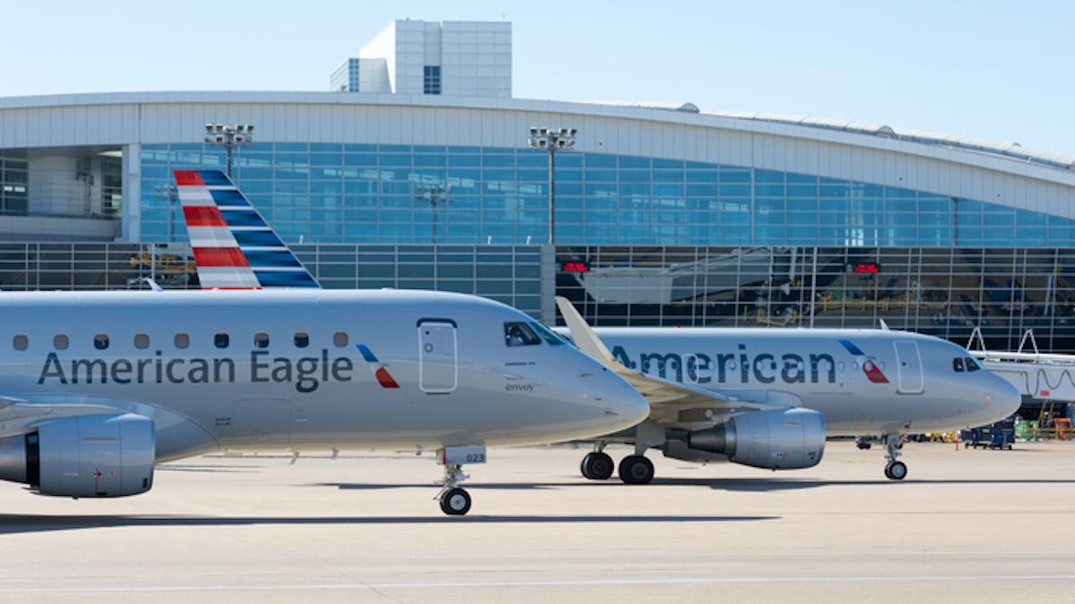 two airplanes parked in front of a building