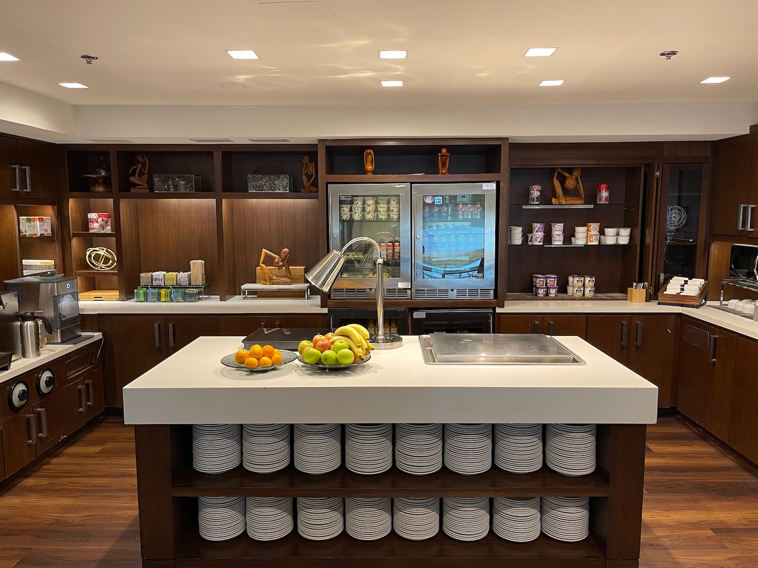 a kitchen with a large counter and a refrigerator