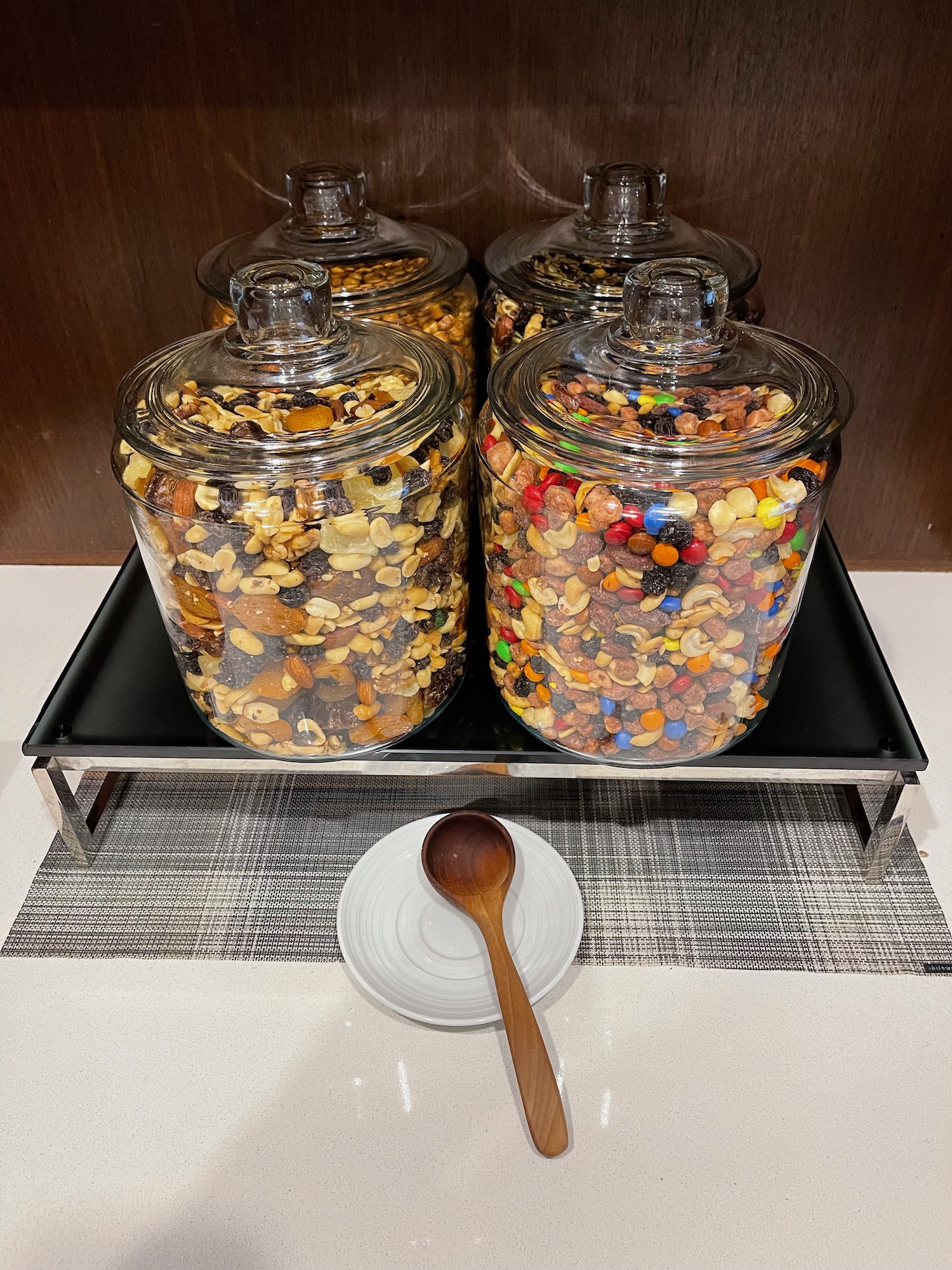 a group of glass jars with nuts and peanuts