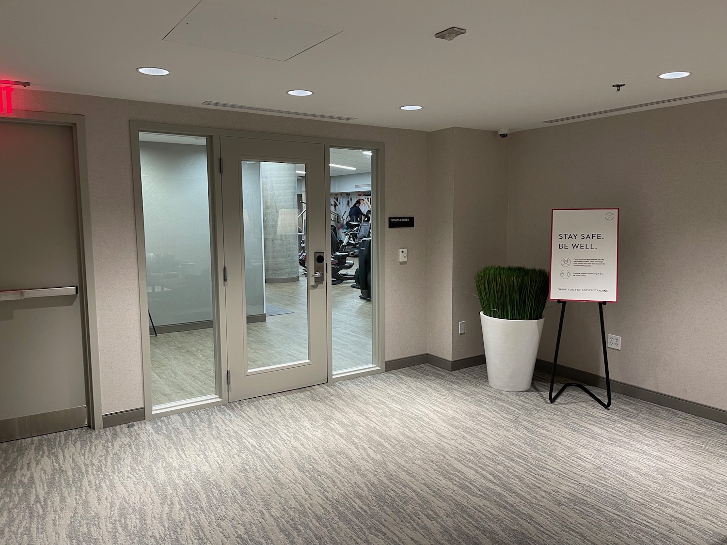 a room with glass doors and a plant