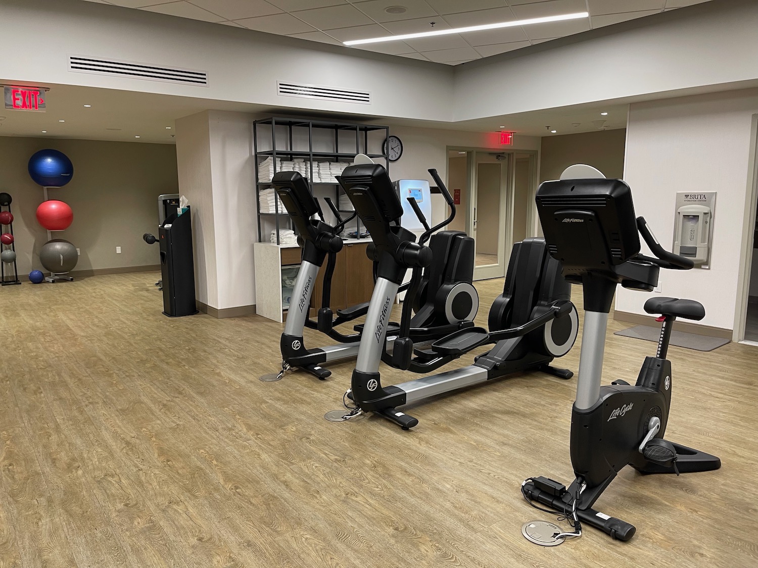 a room with exercise bikes and a wood floor