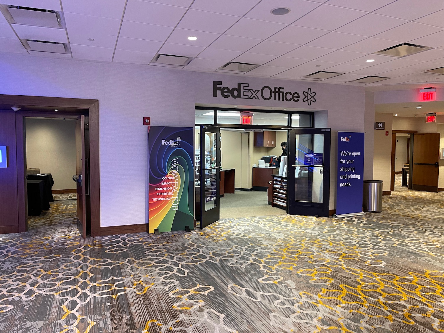 a lobby with a sign and a door