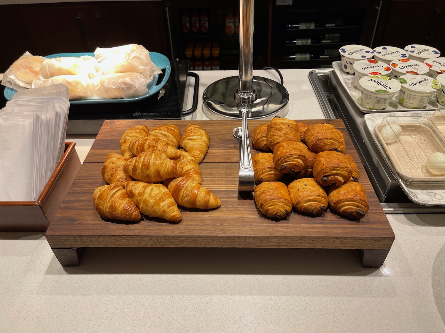 a tray of croissants and yogurt