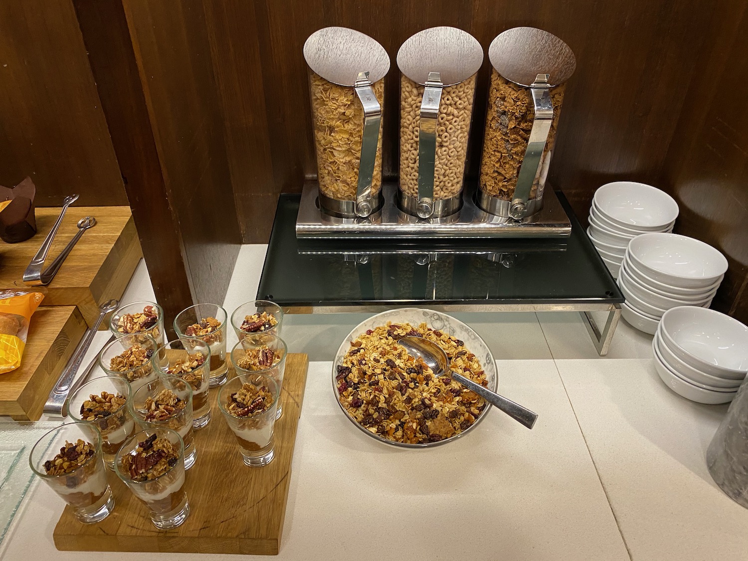 cereal cereals in a bowl and cups of food on a table