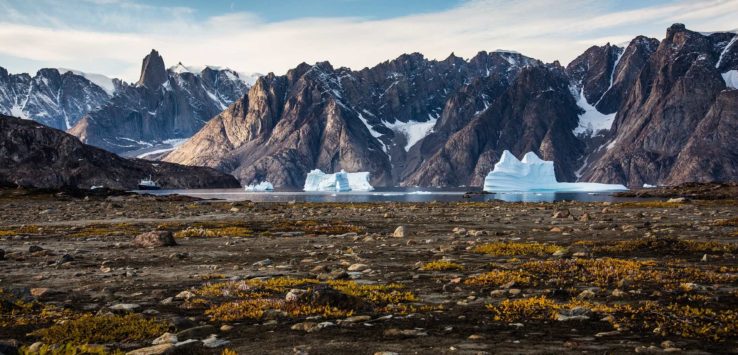 a rocky landscape with icebergs and mountains