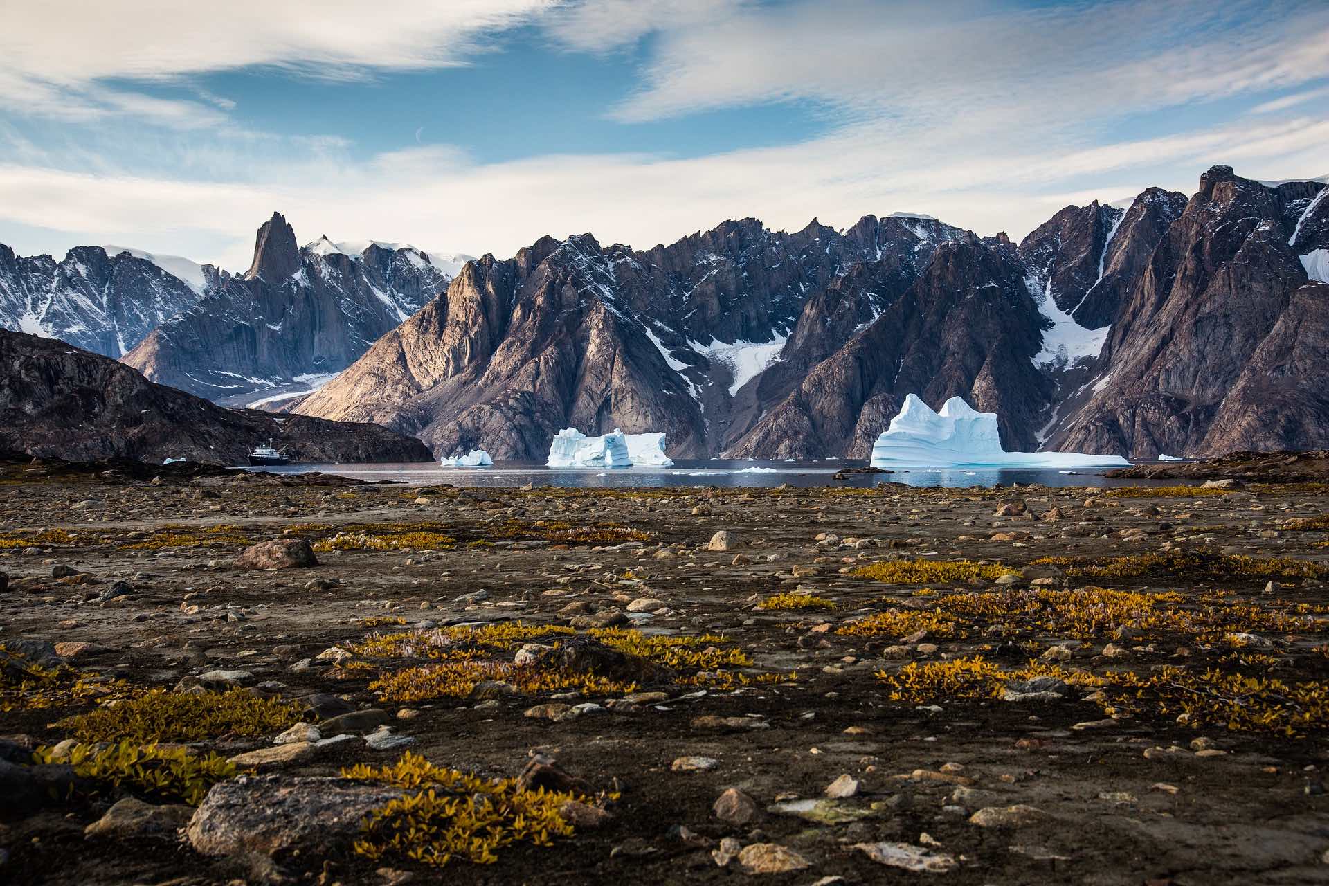 a rocky landscape with icebergs and mountains