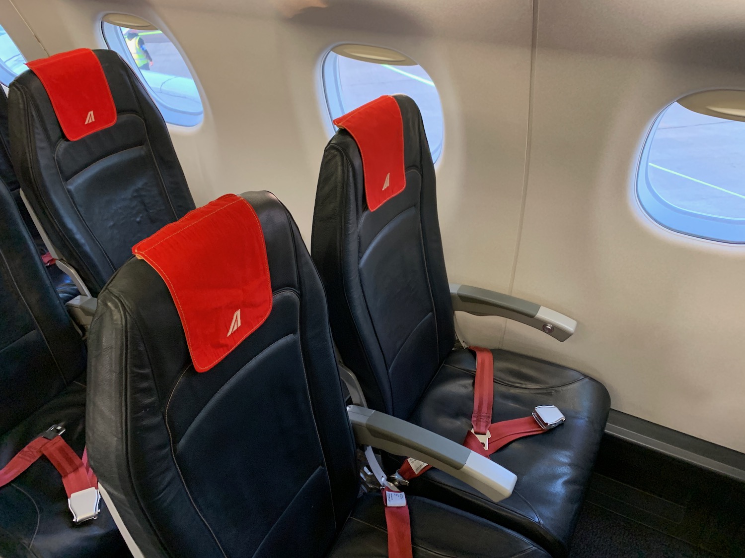 seats in a plane with red seats