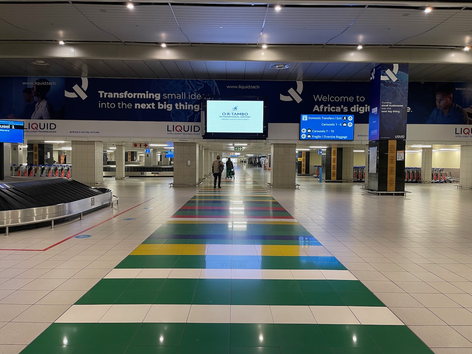 a large airport with luggage carousels