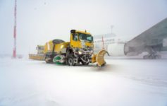 a yellow vehicle on the snow