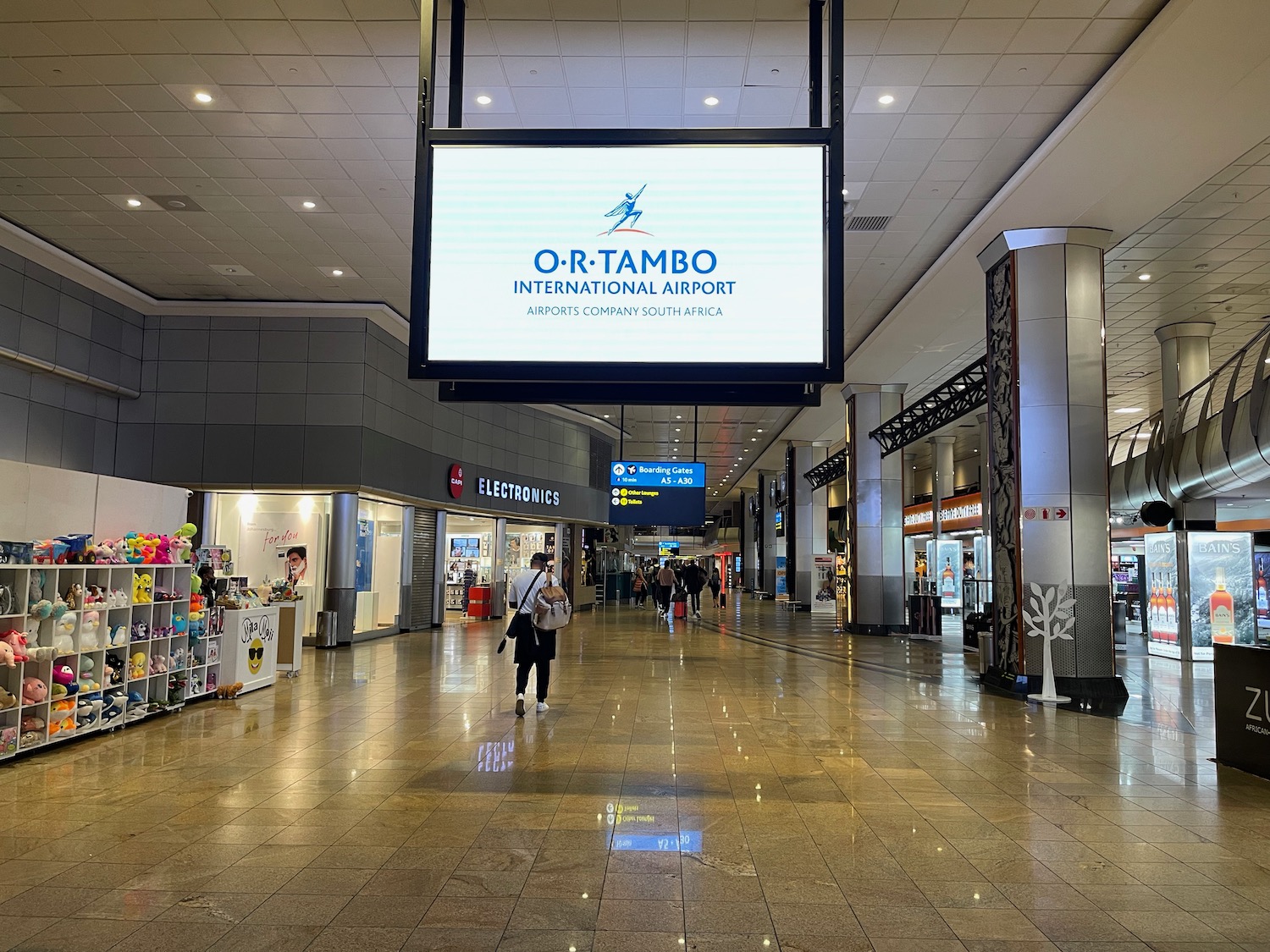 a large rectangular sign in a large airport