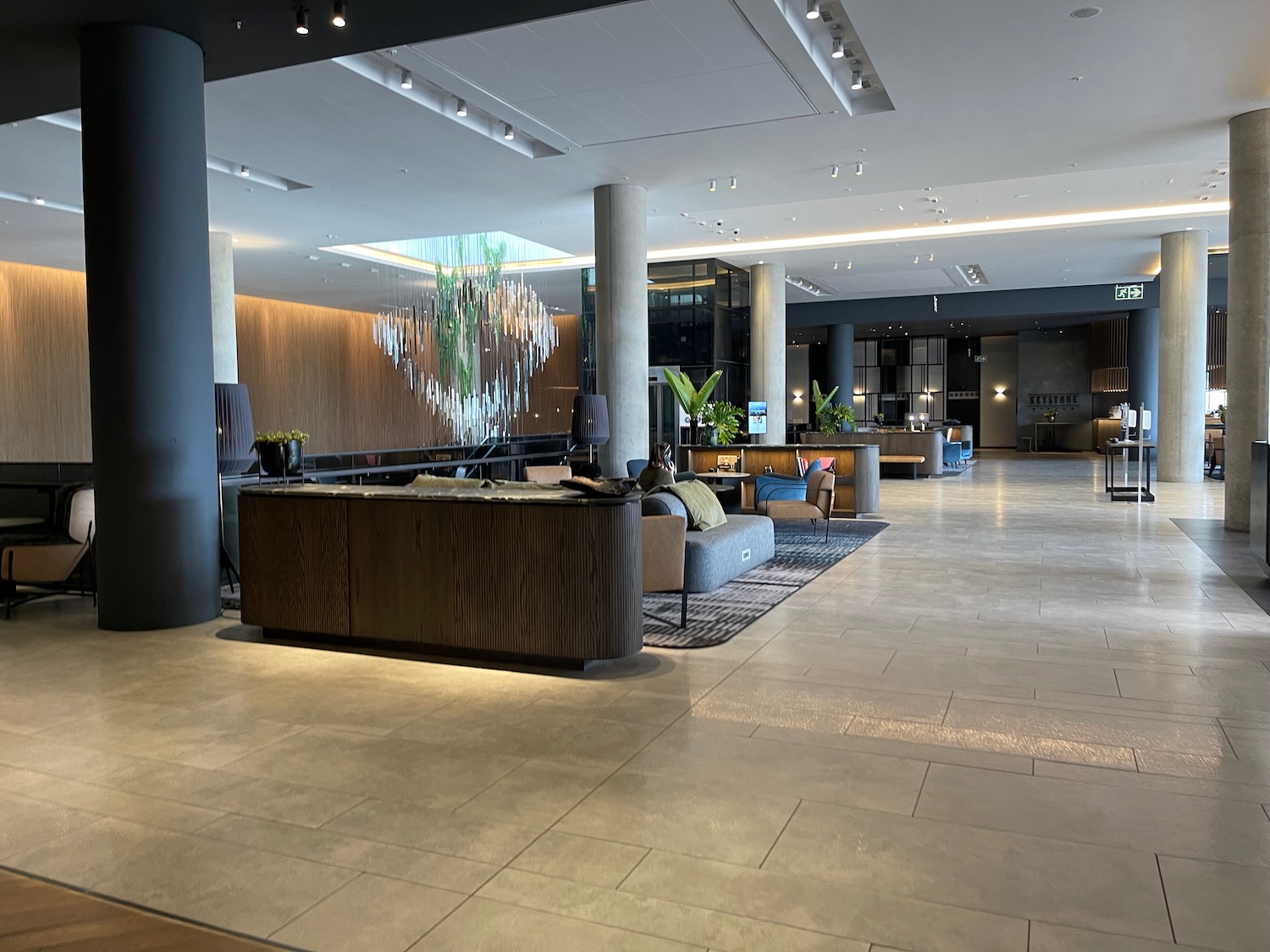 a lobby with a large reception desk and chairs