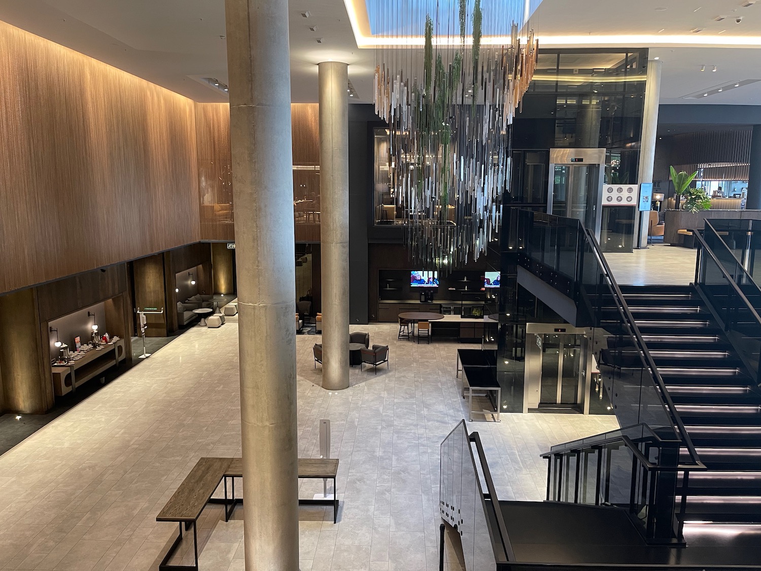 a lobby with stairs and a chandelier