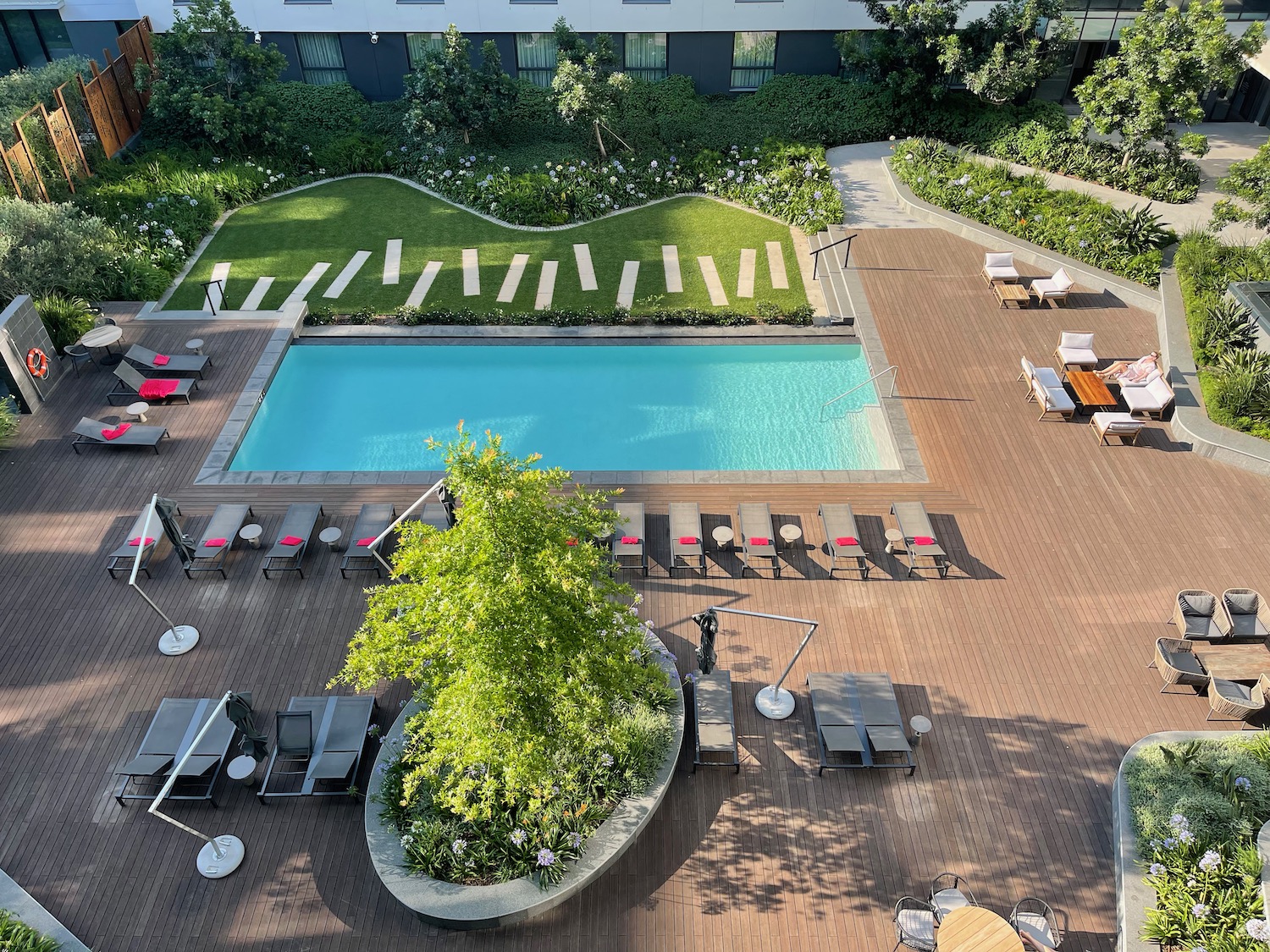 a pool and lounge chairs by a building