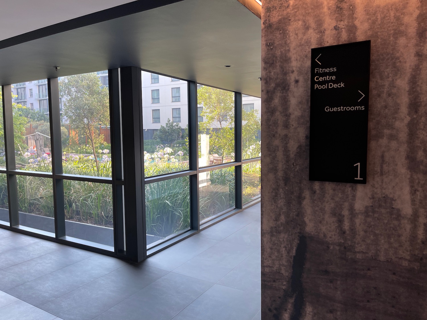 a building with glass walls and a sign