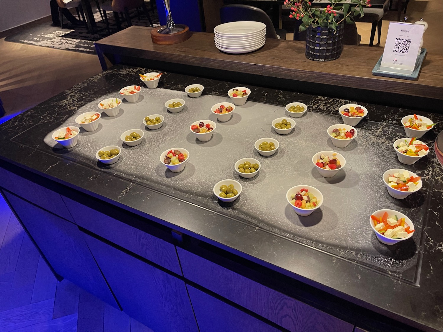 a counter with bowls of fruit and vegetables