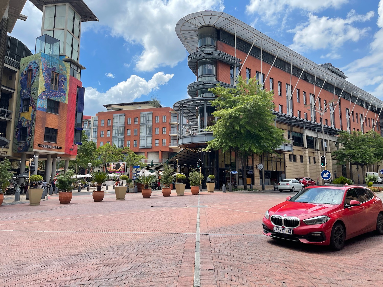 a red car parked in front of a building