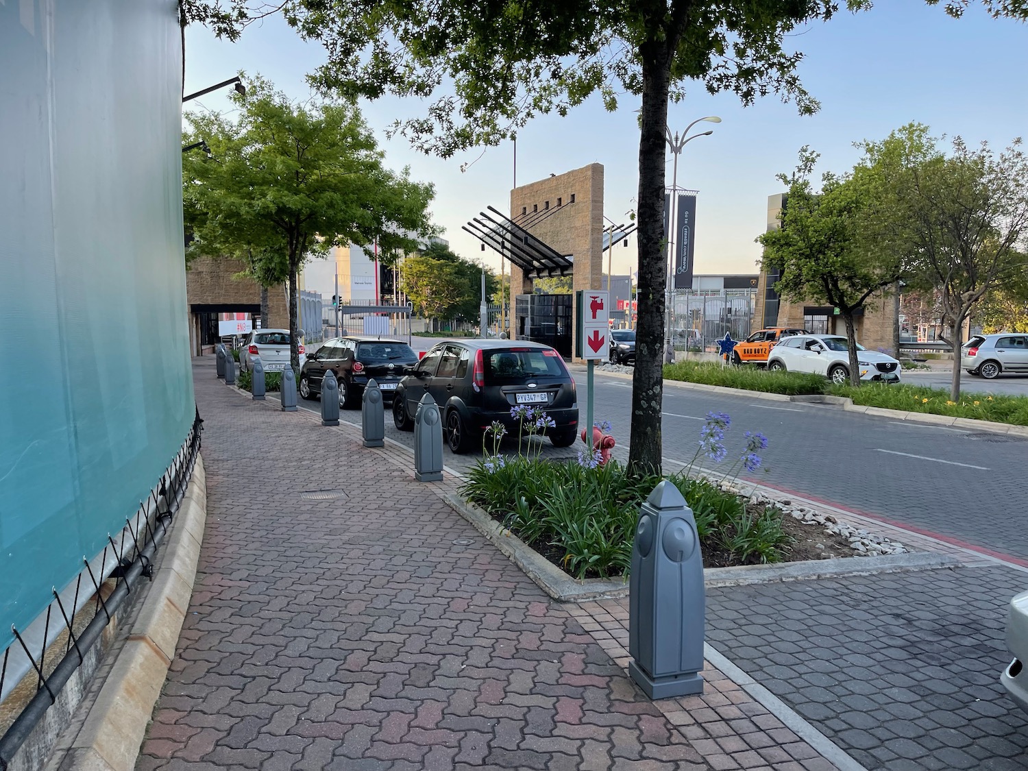 a sidewalk with cars parked on it