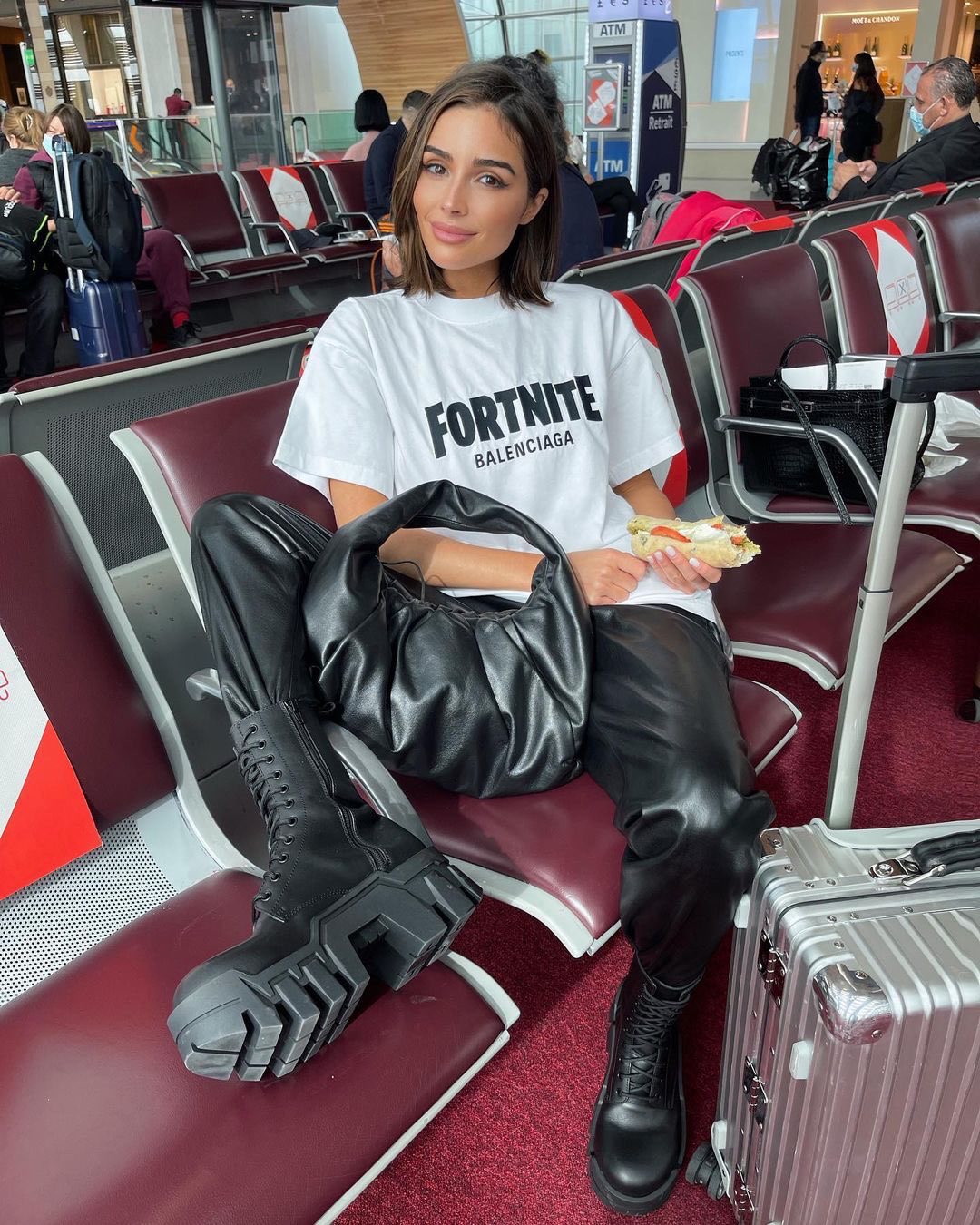 a woman sitting in a chair with luggage