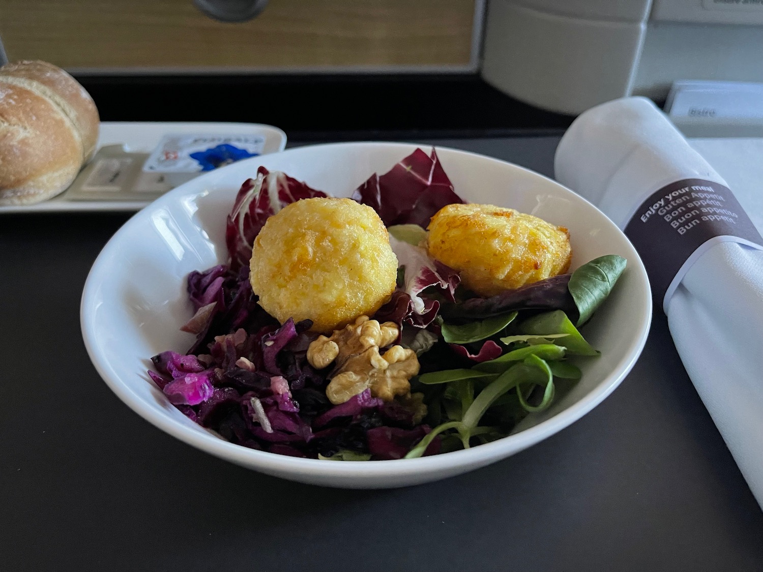 a bowl of salad with food on it